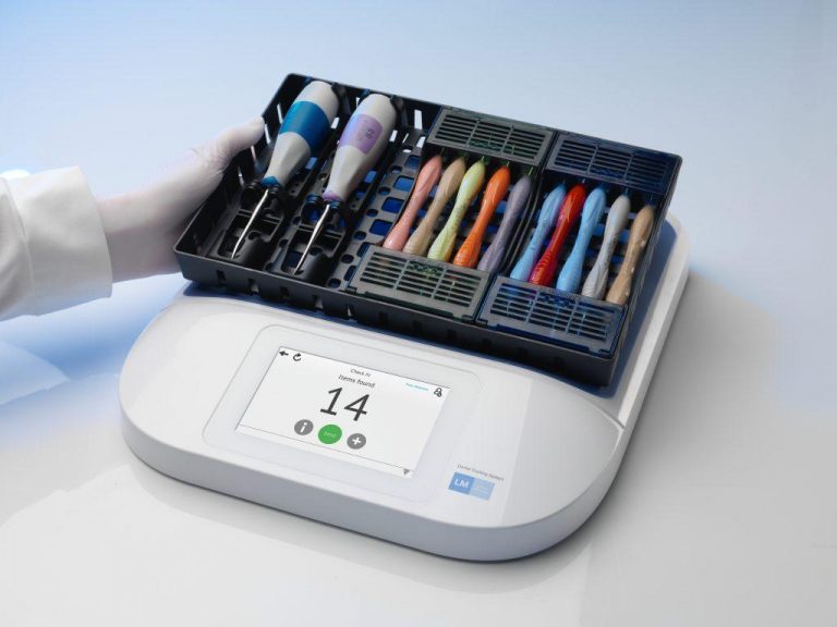 A hand holding a DTS unit reader tray with RFID technology